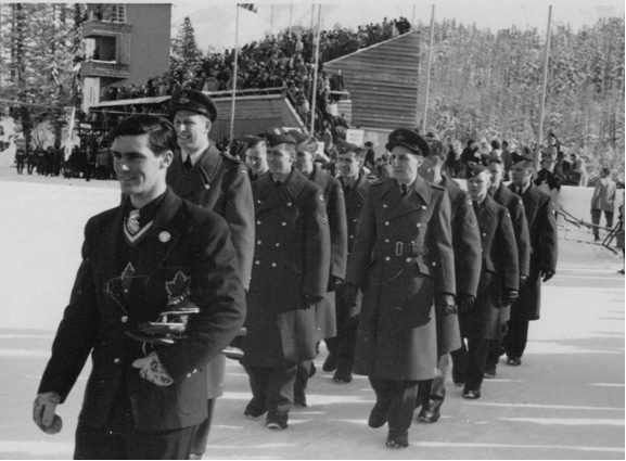 Photo: R.C.A.F. Flyers Hockey Team  March into Stad Olympique at Opening Ceremonies 1948 Winter Olympics